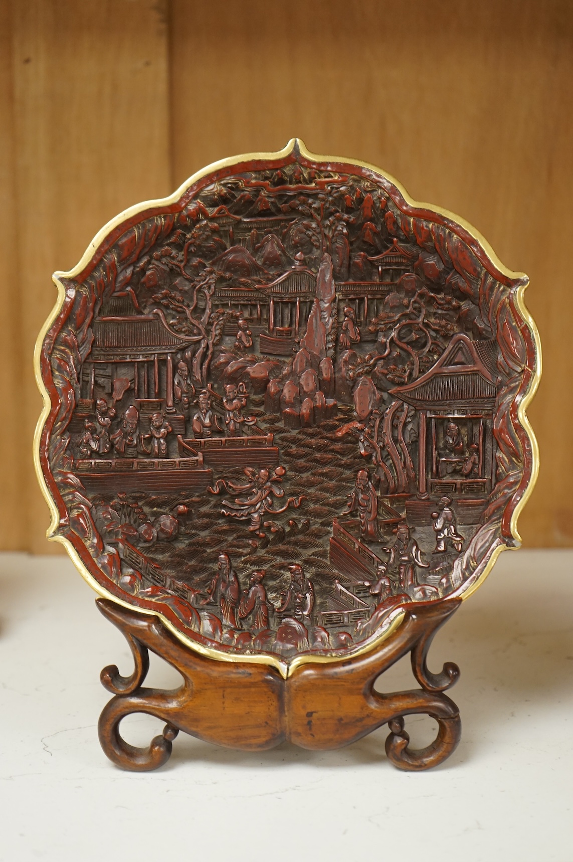 A Chinese lacquer foliate-shaped dish on stand, 18cm in diameter